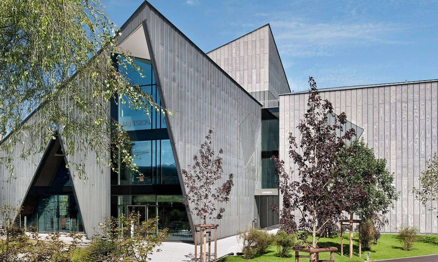 Moderne Architektur mit Jansen‑Stahlsystemen – beeindruckendes Gebäude mit geometrischer Fassade und großflächigen Glas‑ und Metallelementen.